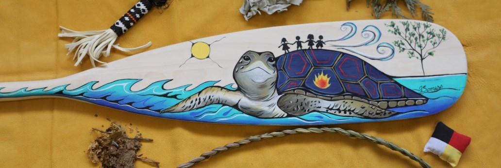 paddle painted with Indigenous artwork