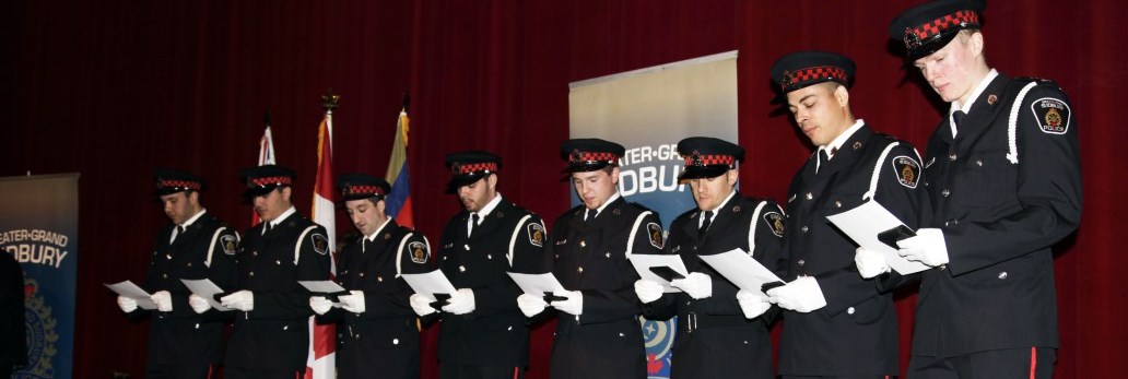 several Auxiliary officers standing in line reading a document