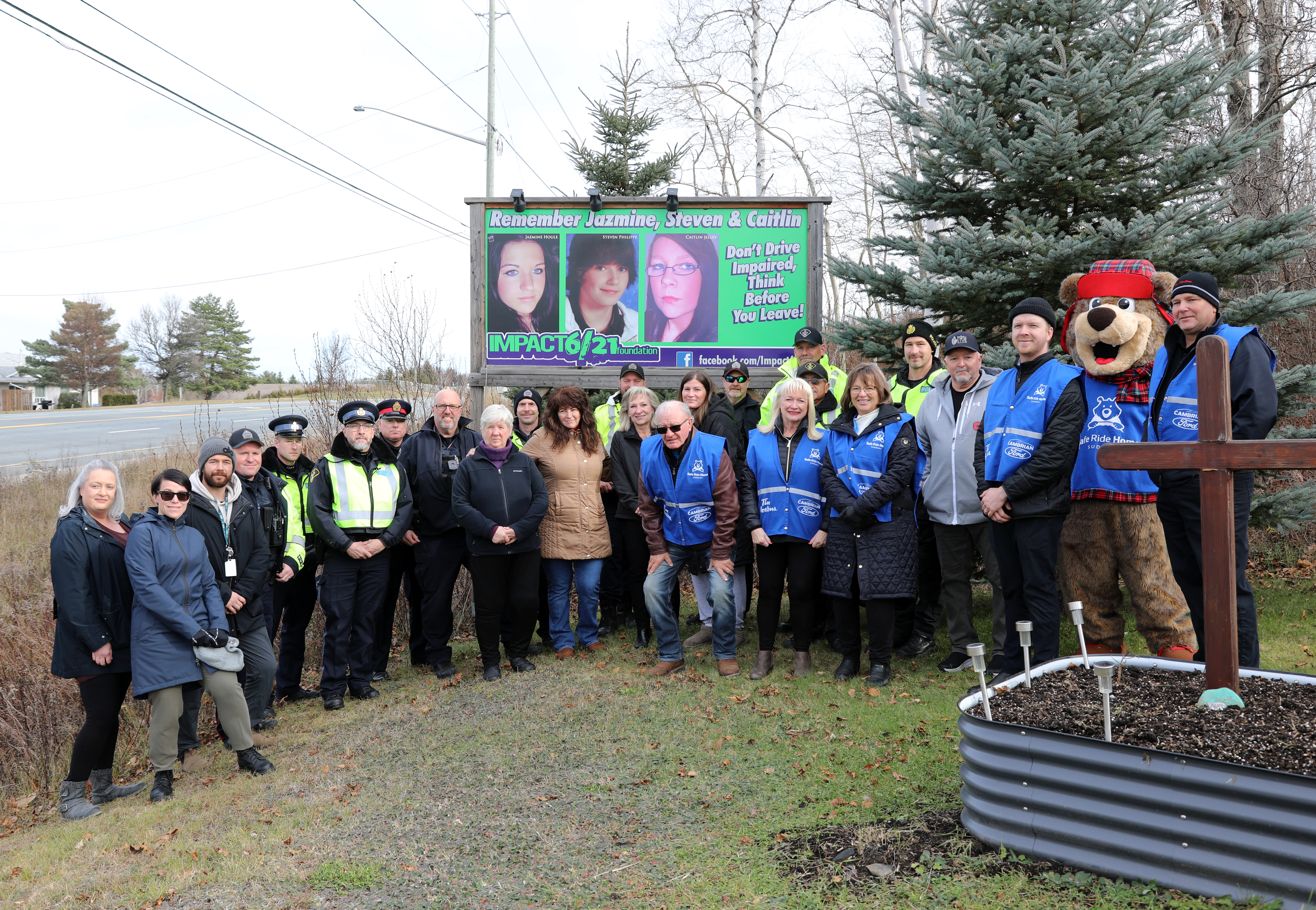 group of people standing in front of sign outside