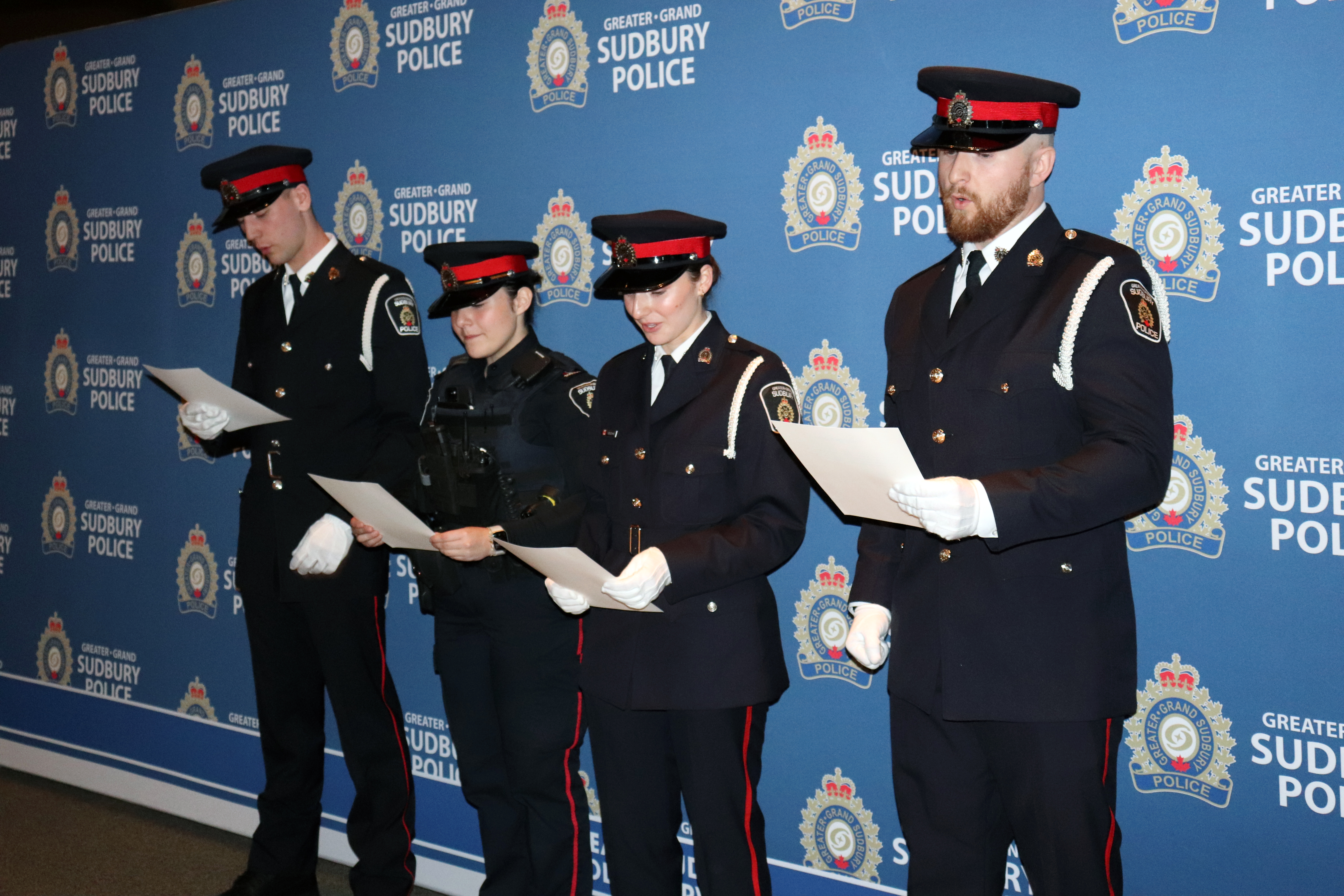 officers in uniform holding papers